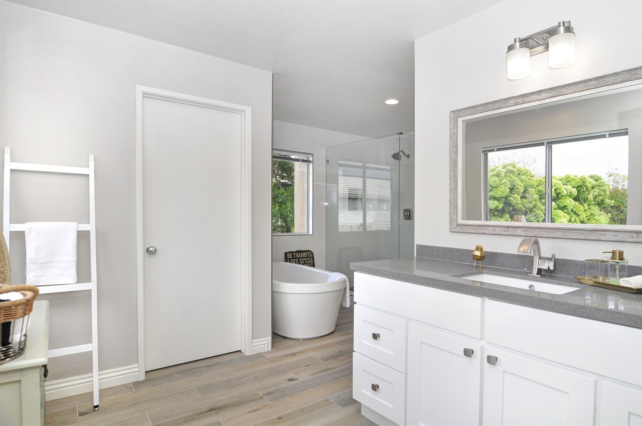 A renovated bathroom with a tiled shower and vanity